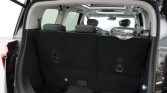 Open SUV rear with upright second-row seats and cargo area, showing a bag on the floor and interior lights on the right side (trunk space)