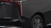 Rear three-quarter view of a dark gray MIFA9 minivan, featuring a distinctive L-shaped taillight and large alloy wheel on the rear corner.