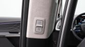 Dual power window switches on a light-colored pillar inside a car.