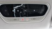 Overhead car console with hazard light button, SOS button, and interior reading lights.