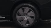 Close-up of a car's front wheel with a geometric multi-spoke alloy rim and low-profile tire.