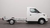 White cab-forward truck with an exposed skeletal rear chassis (no cargo bed) viewed from the side, ready for body install.]","Profile view of a white delivery truck showing only the cab and bare frame extending to the rear." ,"Side view of a small white truck with an empty frame behind the cab for attaching a body or flatbed." ,"White utility truck: cab plus skeletal chassis, no cargo area visible, awaiting installation of a body."