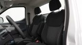 Interior of a car showing the driver seat, front passenger seat, steering wheel, and dashboard.