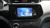 Center console with a large touchscreen infotainment display showing connectivity options, climate controls below, and glossy black trim on the dashboard.