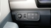 Dashboard control panel featuring a circular lighting/adjustment dial on the left and a row of rectangular buttons labeled ECO and REG nearby.