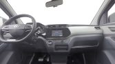Interior of a modern car cockpit with steering wheel, center touchscreen, and dashboard controls visible from the driver’s seat.