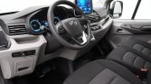 Interior of a modern car with steering wheel, digital instrument cluster, and center touchscreen display