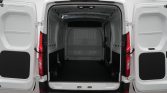 Open rear doors reveal an empty white cargo van interior with a dark floor and paneled walls ready for loading.