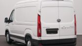 Rear view of a white cargo van with double back doors, black bumper, and tall vertical taillights.