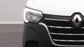 Front view of a white Renault van showing the left headlight and grille with prominent emblem.