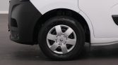 Front wheel area of a white van showing a silver hubcap with Renault logo and a dark front bumper.