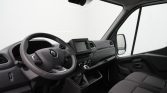 Interior of a Renault van: steering wheel with logo, center touchscreen, climate controls, and front seats