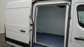 White cargo van with side door open, showing an empty blue-floored cargo space.