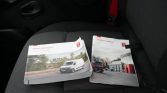 Two Renault Trucks Master booklets laid on a car seat, one showing a white van driving on a highway and the other an exterior of a service center.