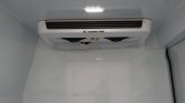 Ceiling-mounted white Thermo King refrigeration unit inside a cold storage trailer or freezer.