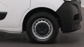 Front wheel of a white van, showing a black bumper and steel hubcap with center cap design