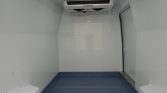 Interior of a clean, empty cold storage space with a Thermo King refrigeration unit mounted on the ceiling and blue non-slip floor.