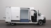 White delivery van with side door open, showing cargo area and front seating inside the cabin