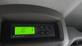 Green backlit Thermo King climate control display showing 10°C and thermometer icon, mounted in a vehicle ceiling panel.