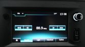 Car radio display tuned to FM 88.9 MHz with playback controls