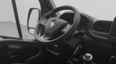 Interior view of a vehicle cockpit with steering wheel, gear shift, and driver-side door panel visible.