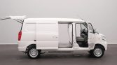 White cargo van with both front and side doors open, exposing an empty cargo area in a studio setting.