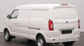 White cargo van photographed from the rear-right, showing closed rear doors and plain side panels in a studio setting, no branding visible.