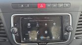 Pantalla táctil del sistema de infoentretenimiento del coche, mostrando iconos de navegación, radio y ajustes.