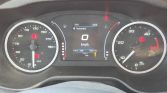 Car dashboard with speedometer on the left, tachometer on the right, and a central display showing 0 km/h and trip data (idle vehicle).