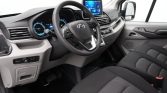 Car interior with steering wheel, digital instrument cluster, and a center touchscreen display visible between the front seats