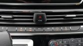 Center car dashboard: hazard triangle button with HOME, row of function switches (AEB, ECO, PWR) and climate controls below.