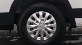 Close-up of a silver alloy wheel with Honda logo on the center cap, mounted on a white vehicle rim.