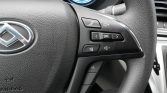 Close-up of a car steering wheel with audio and phone control buttons on the right side.