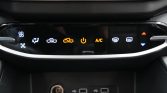 Car climate control panel with illuminated icons for fan, airflow, recirculation, power, A/C, and defrost; USB ports below