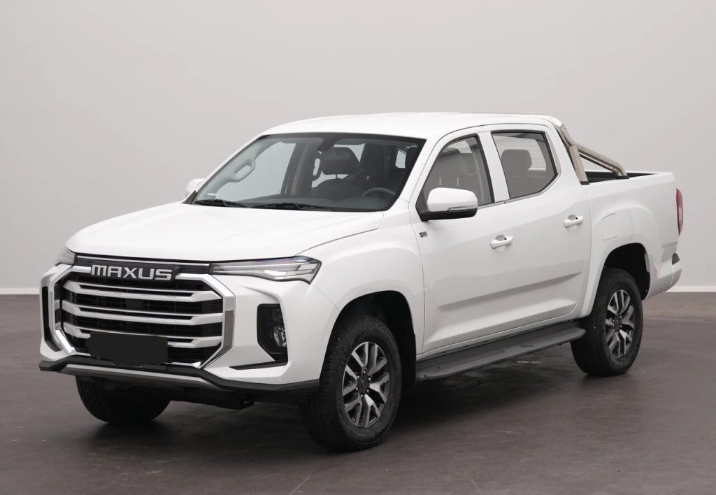 White Maxus pickup truck shown from a front-three-quarter view in a studio setting with a bold grille and chrome accents.