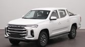 White Maxus pickup truck shown from a front-three-quarter view in a studio setting with a bold grille and chrome accents.