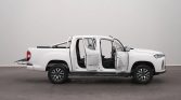 White pickup truck in a studio with all doors open, exposing the interior.