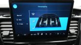 In-car climate control touchscreen showing seat ventilation and airflow diagram on a blue UI panel.