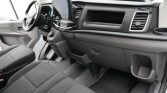 Interior of a modern vehicle showing the dashboard, steering wheel, and a large central touchscreen display above the climate controls.”,
