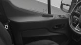 Inside view of a vehicle showing the steering wheel on the right side and the front passenger area, in grayscale