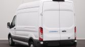 Rear view of a white Ford Transit cargo van with closed double doors and rear lights visible in a studio setting