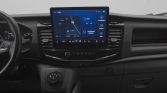 Dashboard interior of a car with a large central touchscreen showing a navigation map and media widgets at the top of the center console