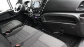 Front interior of a vehicle showing the steering wheel, center console with touchscreen, and two front seats with seatbelts.