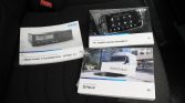 Three IVECO manuals on a car seat: Digital Tachograph DTCO 4.1, Infotainment, and Daily van manual.