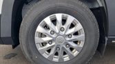 Close-up of a car wheel with a silver hubcap featuring the Hyundai logo on a black tire.