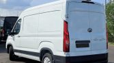 White cargo van parked in a lot, rear doors closed, high roof and dark bumper.