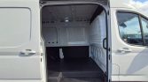 White cargo van with side door open, showing an empty loading area and black cargo floor.