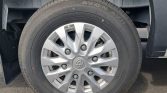 Silver alloy wheel with Hyundai logo center cap mounted on a black tire, showing tread and wheel well.