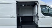 White cargo van with side door open, showing empty, clean cargo space with black rubber floor mat.