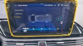 Infotainment screen in a car showing Energy settings with a top-down vehicle diagram and a charging indicator, framed by a yellow protective border.